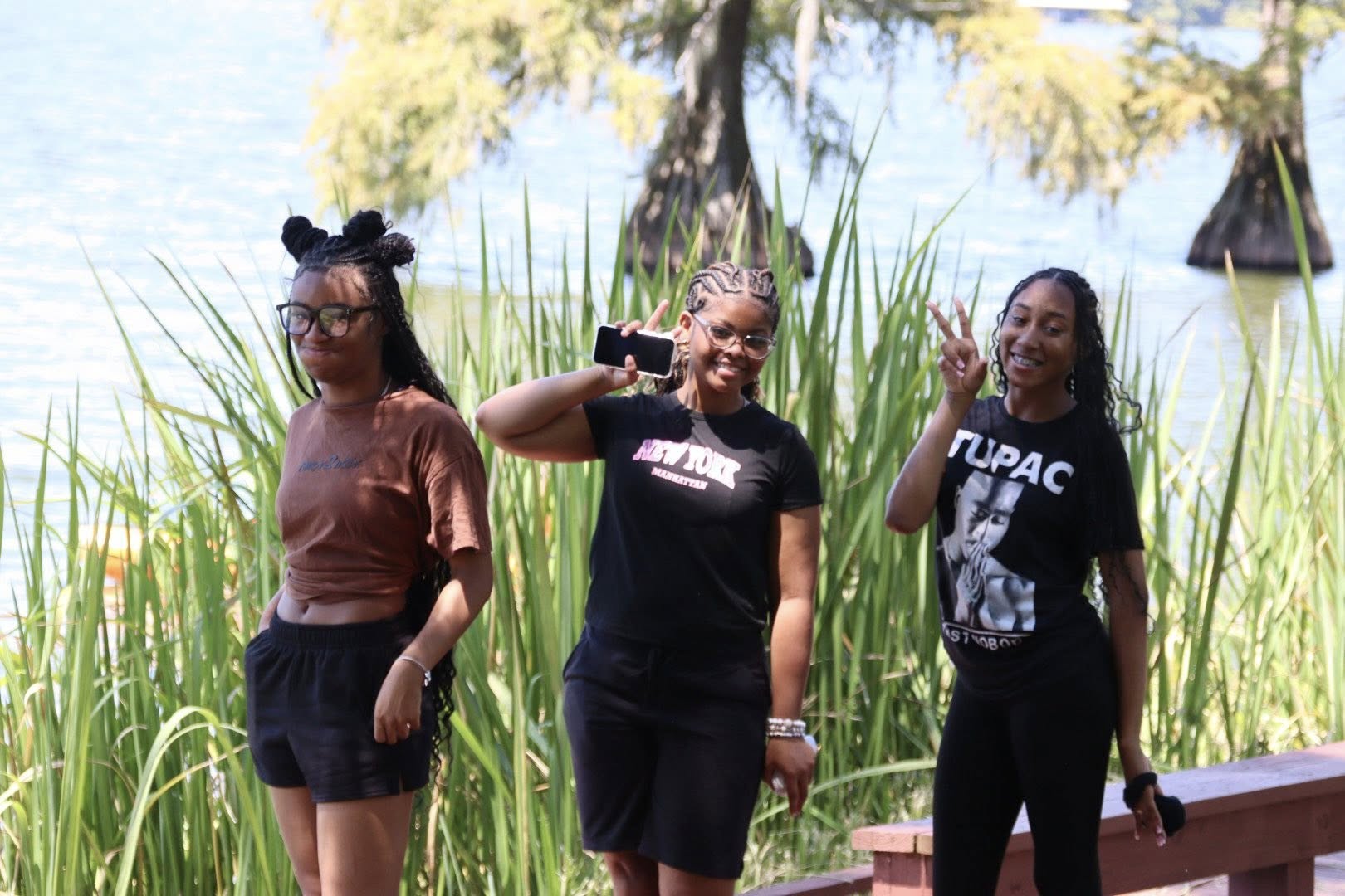 Three teenage girls posing for a picture.